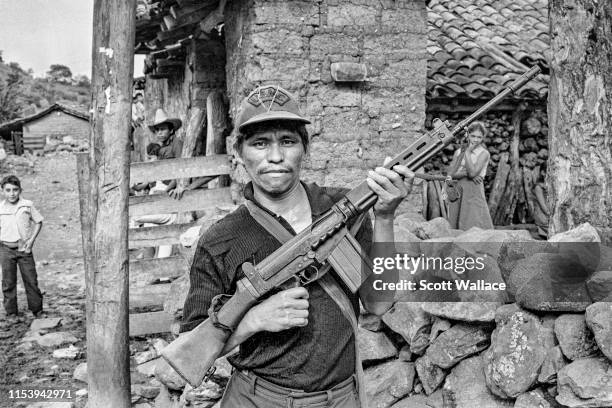 Member of the FMLN militia hoists his rifle in a rebel-held village in Chalatenango Department, El Salvador, 1984.