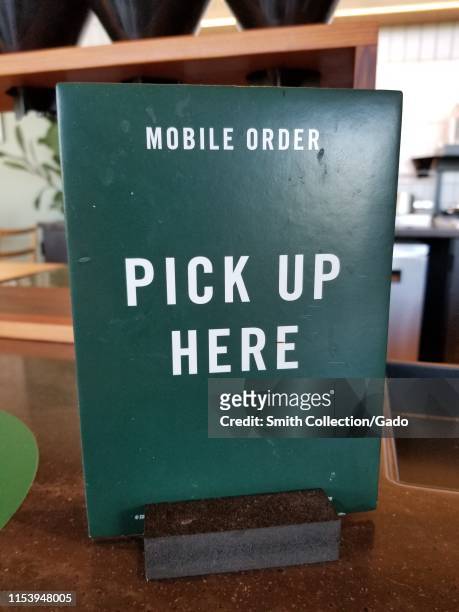 Close-up of sign reading Mobile Order Pickup, part of an app-based mobile ordering system at a Starbucks cafe in San Ramon, California, June 4, 2019.