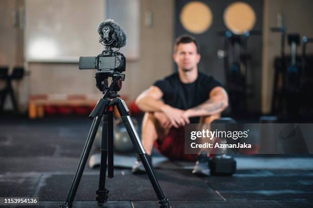 fitness vlogger making a video of himself at the gym - persuasion stock pictures, royalty-free photos & images