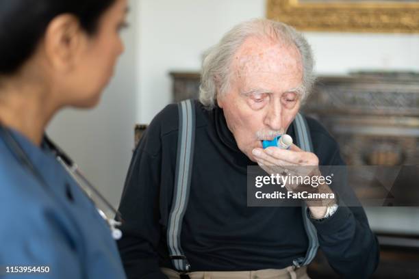 senior man with a puffer - chronic obstructive pulmonary disease stock pictures, royalty-free photos & images