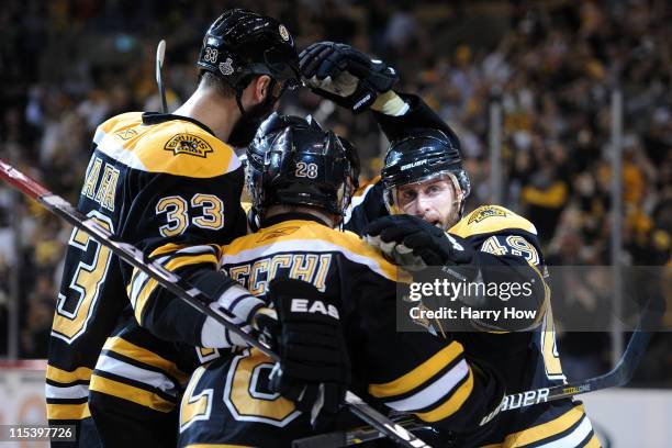 Rich Peverley of the Boston Bruins celebrates with his teammates Zdeno Chara and Mark Recchi after scoring a goal in the second period against...