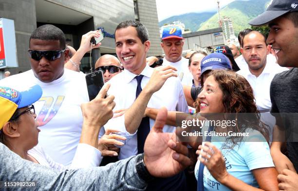 Opposition leader and president of the National Assembly Juan Guaido greets supporters during a demonstration at PNUD as part of the 208th...