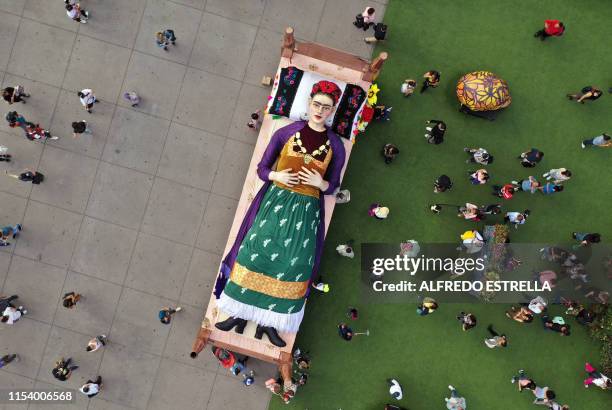 Aerial view of a figure of Mexican artist and painter Frida Kahlo lying in bed taken on the inauguration day of the exhibition "Los Colores de Frida"...