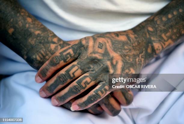 An ex member of the MS-13 gang is pictured at Santa Ana prison, 60 km northwest of San Salvador, on May 21, 2019. - Former members of Salvadoran...