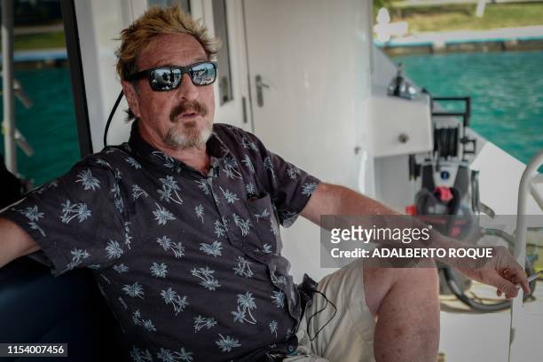Millionaire John McAfee gestures during an interview with AFP on his yacht anchored at the Marina Hemingway in Havana, on June 26, 2019. - After...