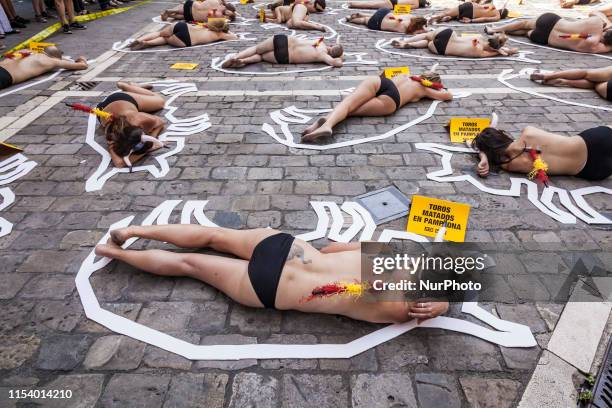 Activists against animal cruelty in bullfightings, lie on the ground like dead bodies inside chalk outlines of bulls during a performance before the...