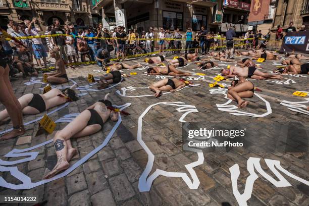 Activists against animal cruelty in bullfightings, lie on the ground like dead bodies inside chalk outlines of bulls during a performance before the...