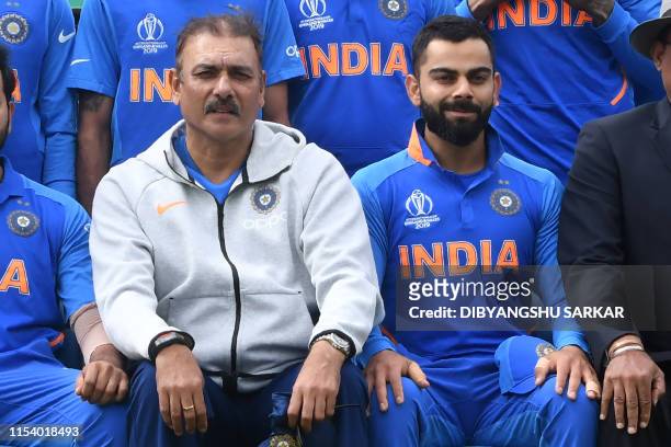 India's head coach Ravi Shastri and India's captain Virat Kohli pose for a group photograph with India team and management ahead of the 2019 Cricket...