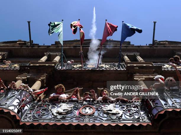 Revellers celebrate during the 'Chupinazo' to mark the kickoff at noon sharp of the San Fermin Festival, in front of the Town Hall of Pamplona,...