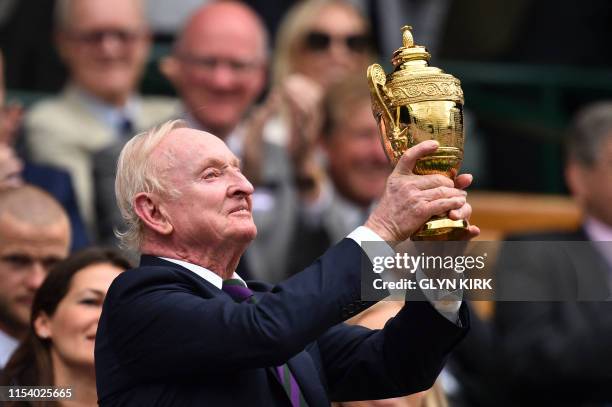 Australian former tennis player Rod Laver holds the Wimbledon Championships men's singles trophy in the Royal Box on Centre Court at The All England...