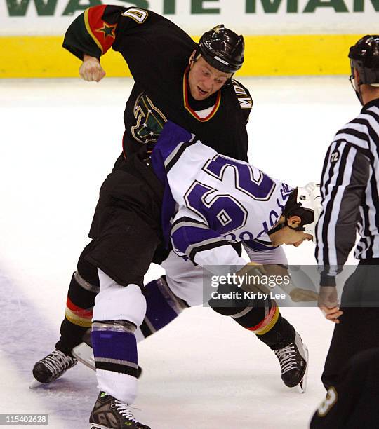 Brennden Morrow of the Dallas Stars hits Tom Kostopoulos of the Los Angeles Kings during a fight. The Kings defeated the Stars, 3-2, in overtime at...