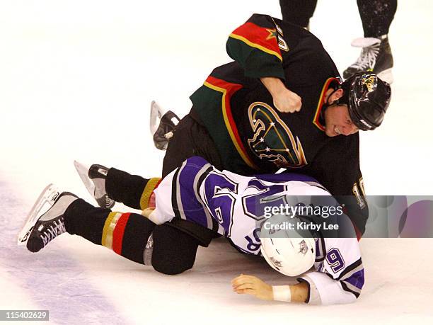 Brennden Morrow of the Dallas Stars hits Tom Kostopoulos of the Los Angeles Kings during a fight. The Kings defeated the Stars, 3-2, in overtime at...