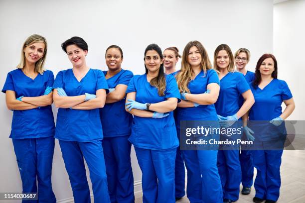 we're ready to be of service - female doctors group stock pictures, royalty-free photos & images