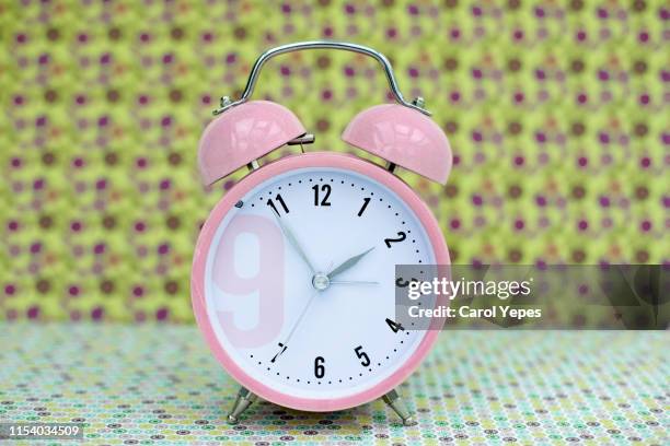 pink alarm clock in vintage background - daylight saving time foto e immagini stock