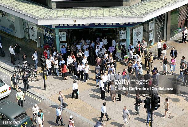 Londoners participate in a two-minute silence in remembrance of those who died in the London bombings that took place on Thursday, July 7, 2005.
