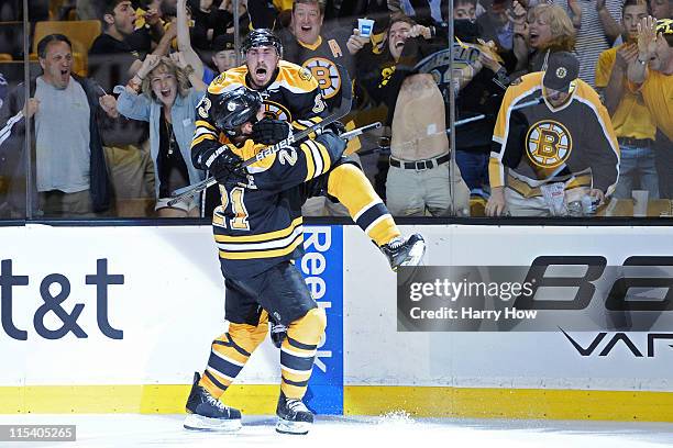 Brad Marchand of the Boston Bruins celebrates with teammate Andrew Ference after scoring a goal in the second period against Roberto Luongo of the...