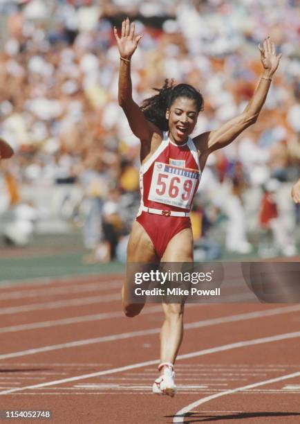 Florence Griffith-Joyner of the United States celebrates winning gold in the Women's 100 metres final event during the XXIV Summer Olympic Games on...