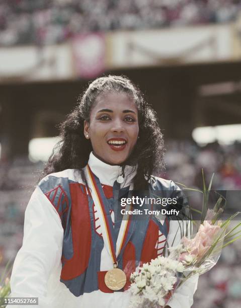 Florence Griffith-Joyner of the United States celebrates with her gold medal after winning the Women's 100 metres final event during the XXIV Summer...