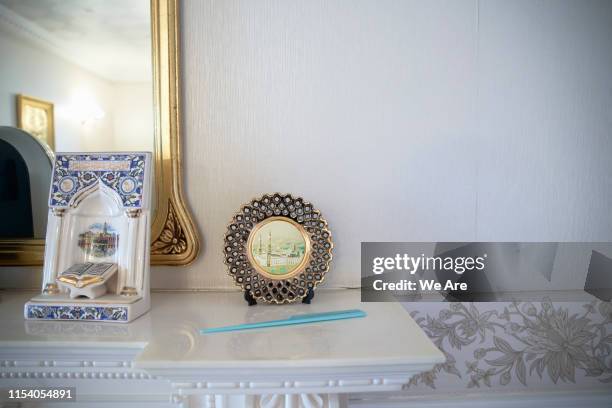 ornamental religious objects on mantlepiece - arabic ornament stock-fotos und bilder