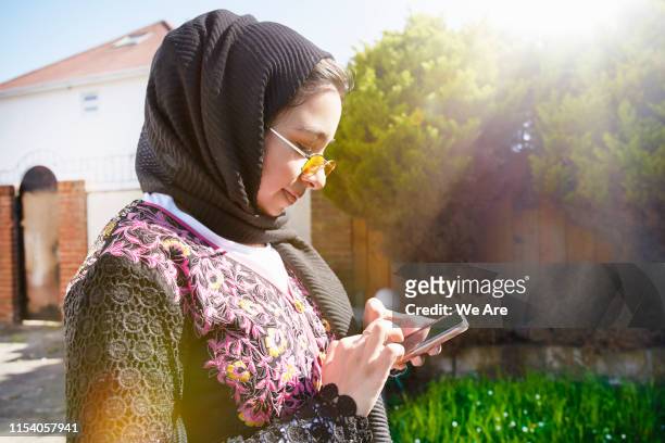 Young muslim woman using smartphone