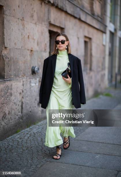 Swantje Sömmer is seen wearing neon pleated dress By Malene Birger, black blazer Arket, Zara sandals, Tory Burch bag, Tom Ford sunglasses on June 05,...