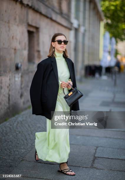 Swantje Sömmer is seen wearing neon pleated dress By Malene Birger, black blazer Arket, Zara sandals, Tory Burch bag, Tom Ford sunglasses on June 05,...