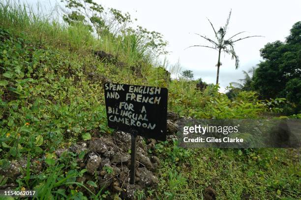 Sign saying " Speak English or French for a bilingual Cameroon" outside a now abandoned school on May 22, 2019 in a rural part of SW Cameroon.In...