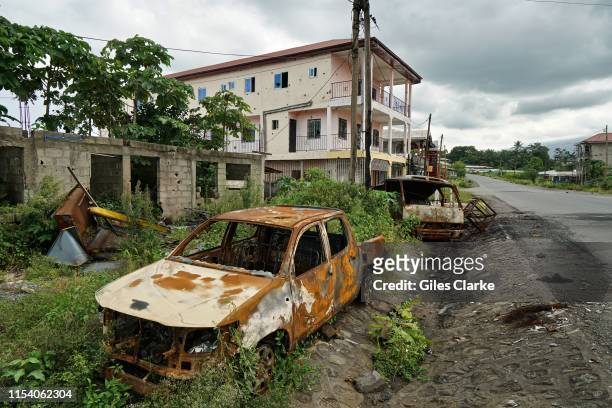 Destroyed car and buildings in a small town on the main highway on May 11, 2019 near Buea. These towns were attacked by the military as suspected...