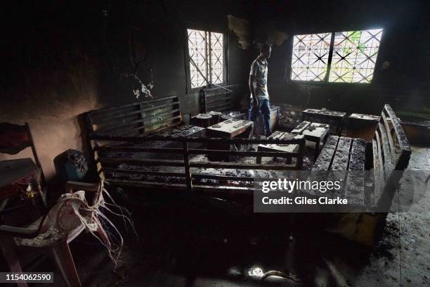 Local man walks thru a burnt-out restaurant on May 11, 2019 that was destroyed in fighting between armed Anglophone separatists and Cameroonian...