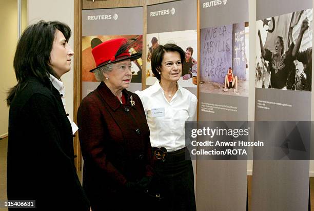 The Queen Elizabeth II is shown a photographic exhibition of pictures by Reuters photographer Zohra Bensemra by Reuters' Senior Vice President and...