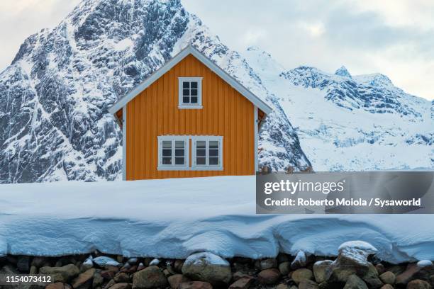 fisherman cabin (rorbu) in snow, sakrisoy, norway - cabin scandinavia stock pictures, royalty-free photos & images