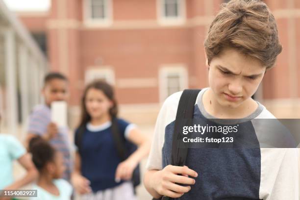 junior high age boy being bullied at school. - boys mobile phone group stock pictures, royalty-free photos & images