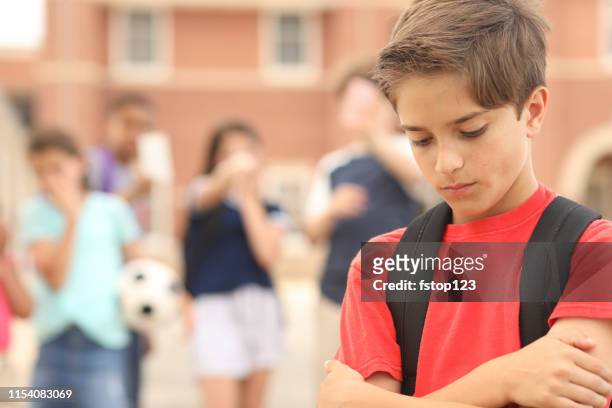 elementary age boy being bullied at school. - bullying stock pictures, royalty-free photos & images