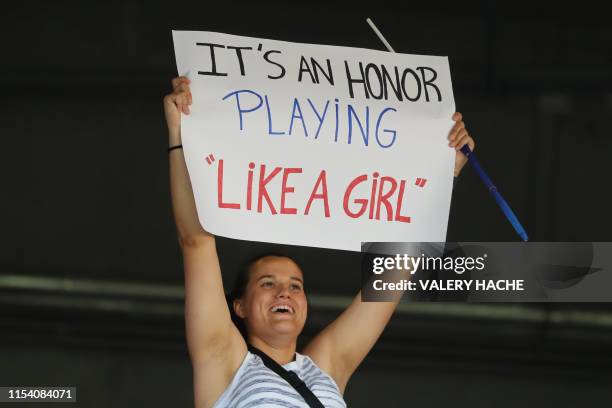 Supporter holds a banner reading "it's an honor playing like a girl" during the France 2019 Women's World Cup third place final football match...