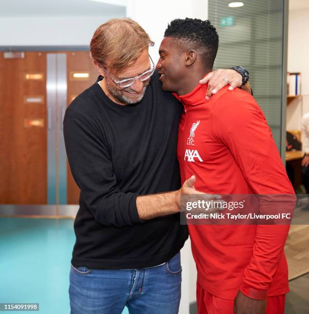 Manager Jurgen Klopp of Liverpool with Taiwo Awoniyi on the first day back of pre-season at Melwood Training Ground on July 6, 2019 in Liverpool,...