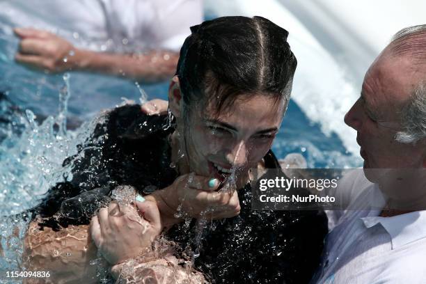 People are baptized the second day of the Jehovahs Witnesses Convention at the Olympic stadium in Athens Greece on July 6, 2019