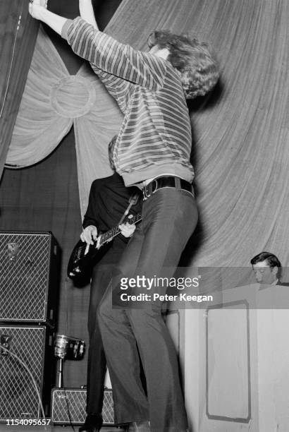 John Walker performing with American pop group The Walker Brothers, at the Granada cinema, Tooting, London, 27th April 1966. The band are touring...