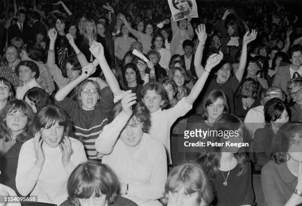 The audience at a performance by American pop group The Walker Brothers, at the Granada cinema, Tooting, London, 27th April 1966. A fan at the back...
