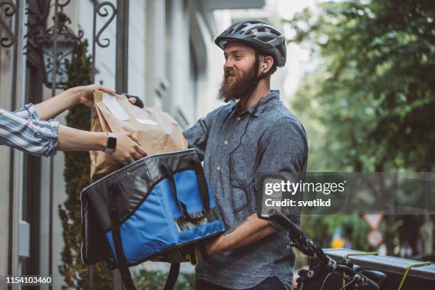 bicycle delivery - bicycle courier stock pictures, royalty-free photos & images