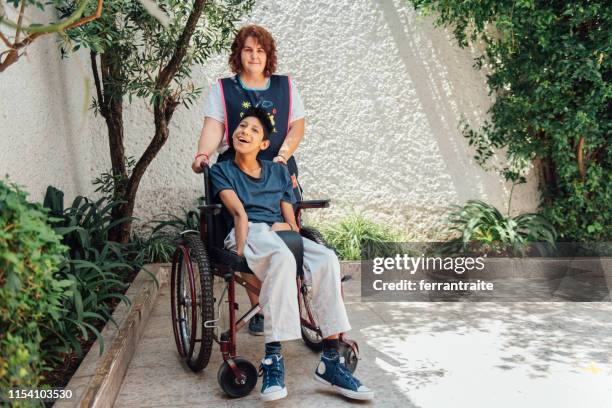 healthcare worker helping patient with cerebral palsy - developmental disability stock pictures, royalty-free photos & images