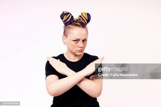 i said, no. frustrated woman shows her crossed arms in gesture sign and looks on camera. stop sign. the woman has hairdo and dreadlocks on her head, freckles on her face. - women arms crossed stock pictures, royalty-free photos & images