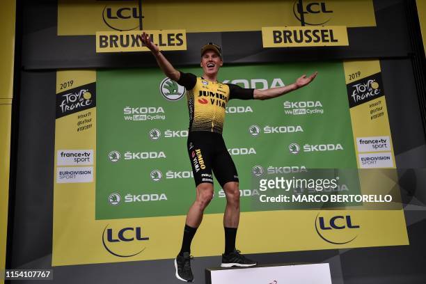 Dutch rider Mike Teunissen celebrates before putting on his best sprinter's green jersey on the podium of the first stage of the 106th edition of the...