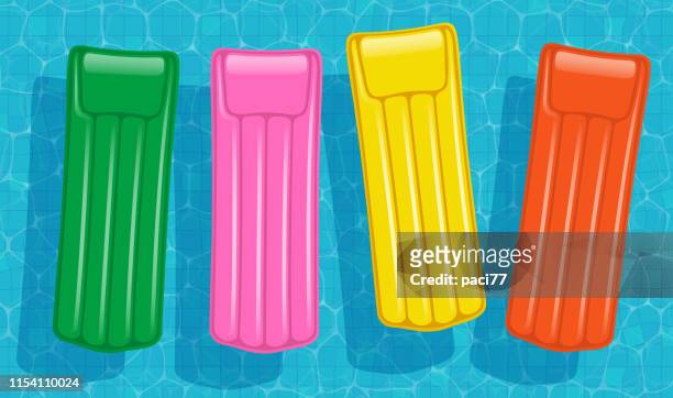 multicolored air mattresses - vector - floating on water stock illustrations