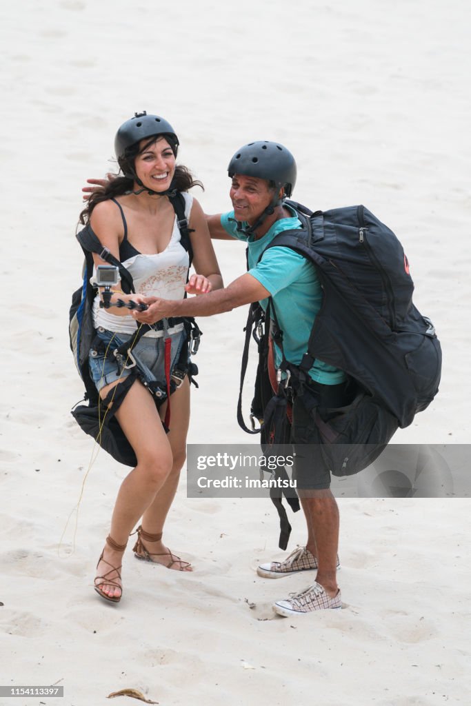 Young woman with a paraplan instructor at Sao Conrado beach