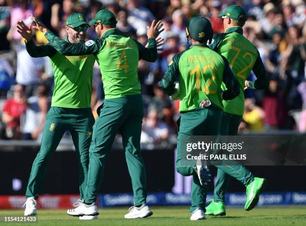 South Africa's Aiden Markram celebrates with teammates including captain Faf du Plessis after taking a catch for the dismissal of Australia's captain...