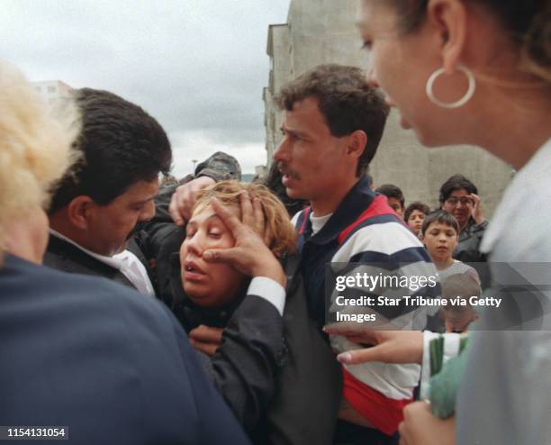 Chanov, Czech Republic. July 9, 1999. Roma Funeral. -- Relatives and friends tried to help a woman who had fainted during the funeral procession for...
