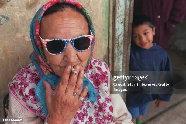 Chanov, Czech Republic. July 9, 1999. A Roma woman who√ïs son nicknamed her Sharon Stone for her star-spangled sunglasses. Nearby is her grandson. --...