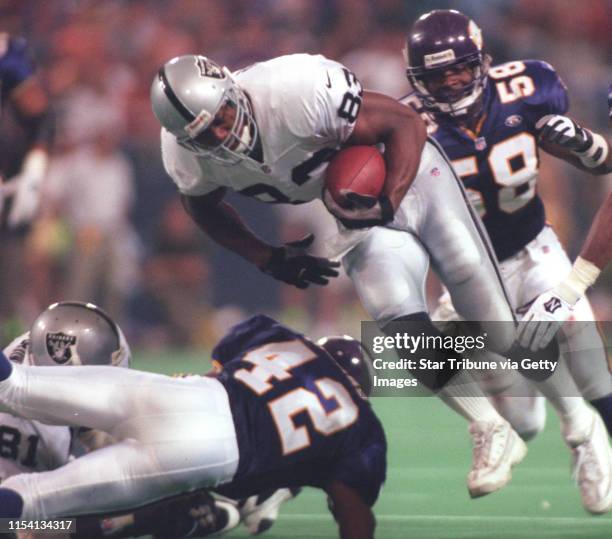 Minneapolis, MN 9/19/99 - metrodome - Vikings vs Oakland -- Oakland√ïs Rickey Dudley carries the ball during the second half as Minnesota√ïs Orlando...