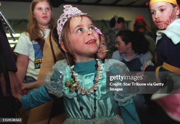 Purim -- Samantha Hamlin, center came dressed as Queen Esther, the heroine of the Purim holiday. On the right, Aaron Sussman sports a handpainted...