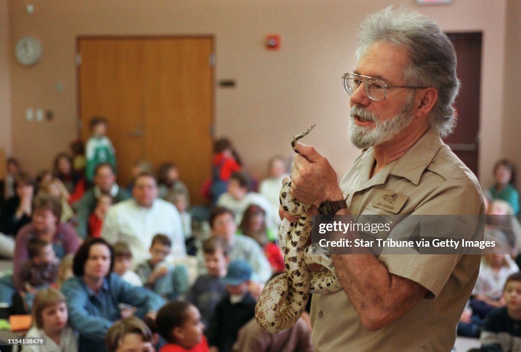 James Gerholdt and his "Remarkable Reptiles" -- -- (THIS PHOTO_Wednesday,03/29/00_Crystal) - - James Gerholdt shows a bullsnake, Minnesotaís largest snake, to the group of about 100 (mostly children) gathered at the Rockford Road Community Library i